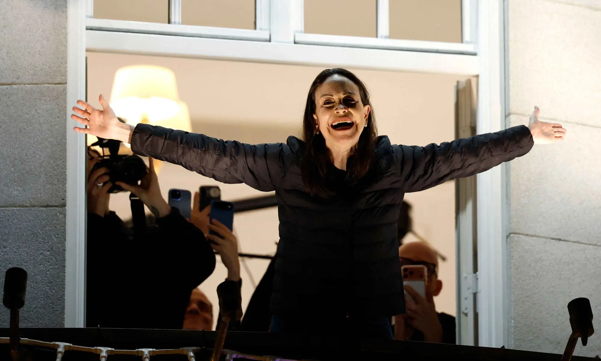 Nobel peace laureate Maria Corina Machado greets supporters from a balcony of the Grand Hotel in Oslo, Norway, early on December 11, 2025. &mdash; AFP