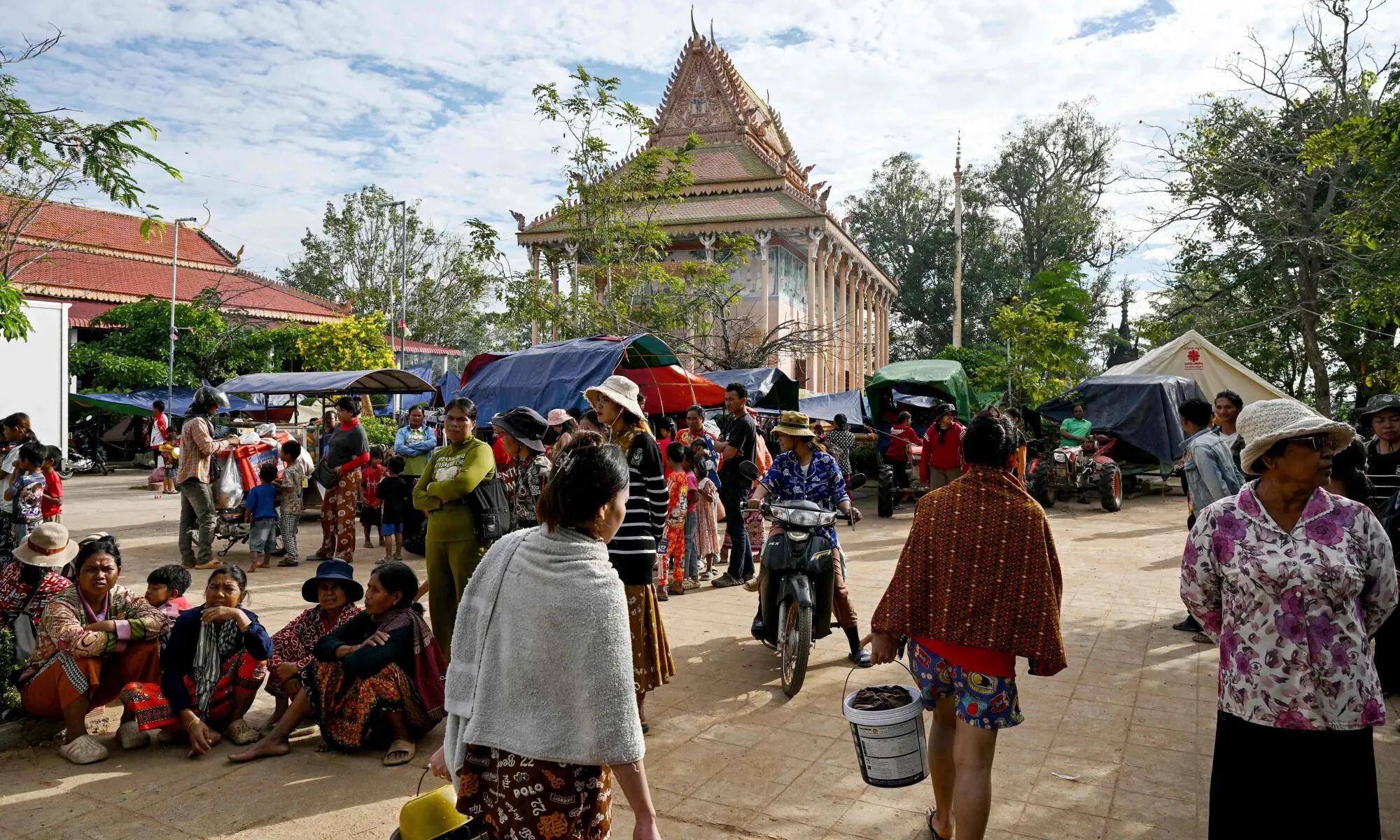 Displaced residents walk at a temporary camp set up at a pagoda during clashes along the Cambodia-Thailand border in Cambodia&rsquo;s Siem Reap province on December 11, 2025. &mdash; AFP