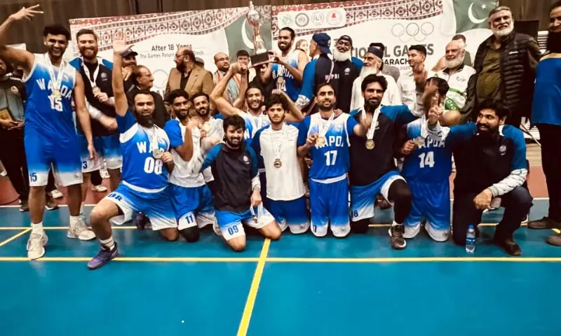 Wapda players celebrate with the National Games basketball trophy after beating Army in the final at the North Nazimabad Gymkhana in Karachi on December 11, 2025.&mdash;Courtesy KBBA