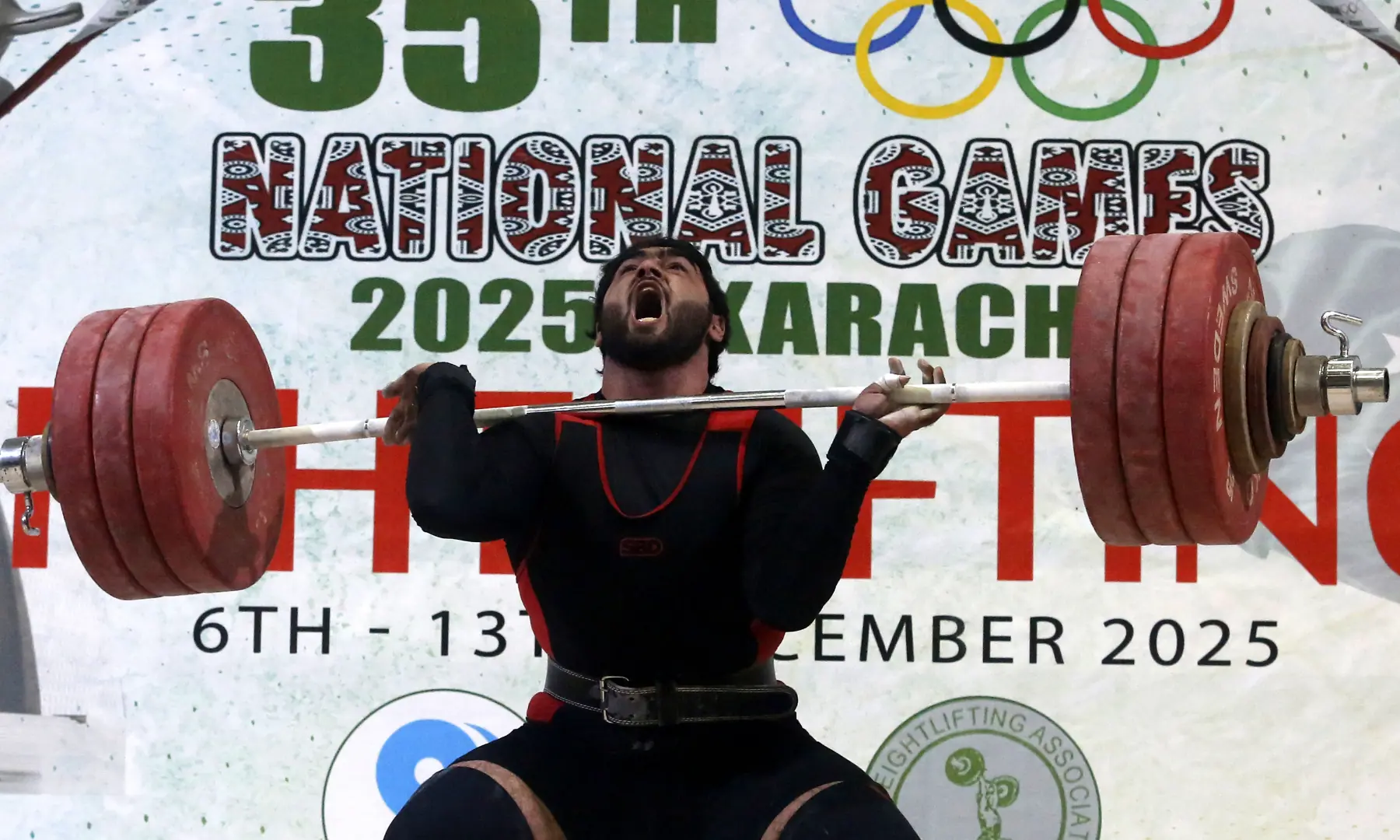 Wapda&rsquo;s Hanzala Dastagir Butt in action during the men&rsquo;s clean and jerk in the weightlifting 110kg category on Friday. &mdash; Photo via Shakil Adil