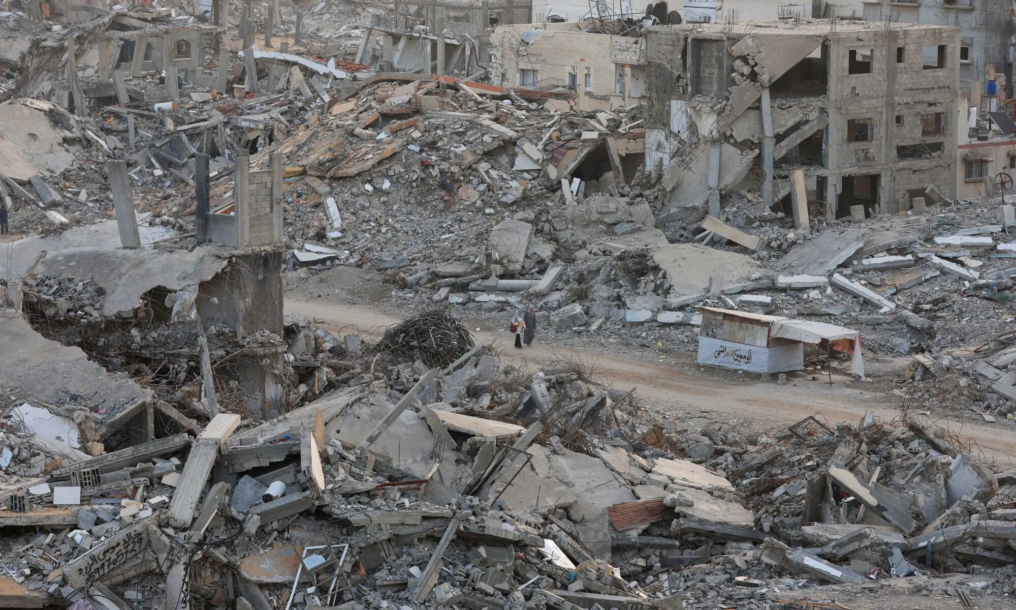 Palestinian women walk among piles of rubble and damaged buildings, in Gaza City, November 24, 2025. — Reuters Palestinian women walk among piles of rubble and damaged buildings, in Gaza City, November 24, 2025. — Reuters