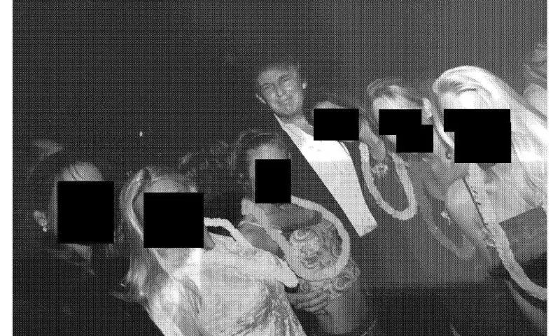   This undated photo from the personal collection of Jeffrey Epstein provided by the Democrats on the House Oversight Committee on December 12, 2025, shows US President Donald Trump (C) posing with a group of women wearing Hawaiian-style leis. &mdash; AFP  