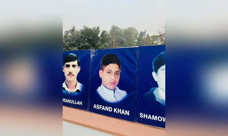A banner shows the portraits and names of victims of the 2014 Army Publis School massacre, in Peshawar on December 15. — Photo via author