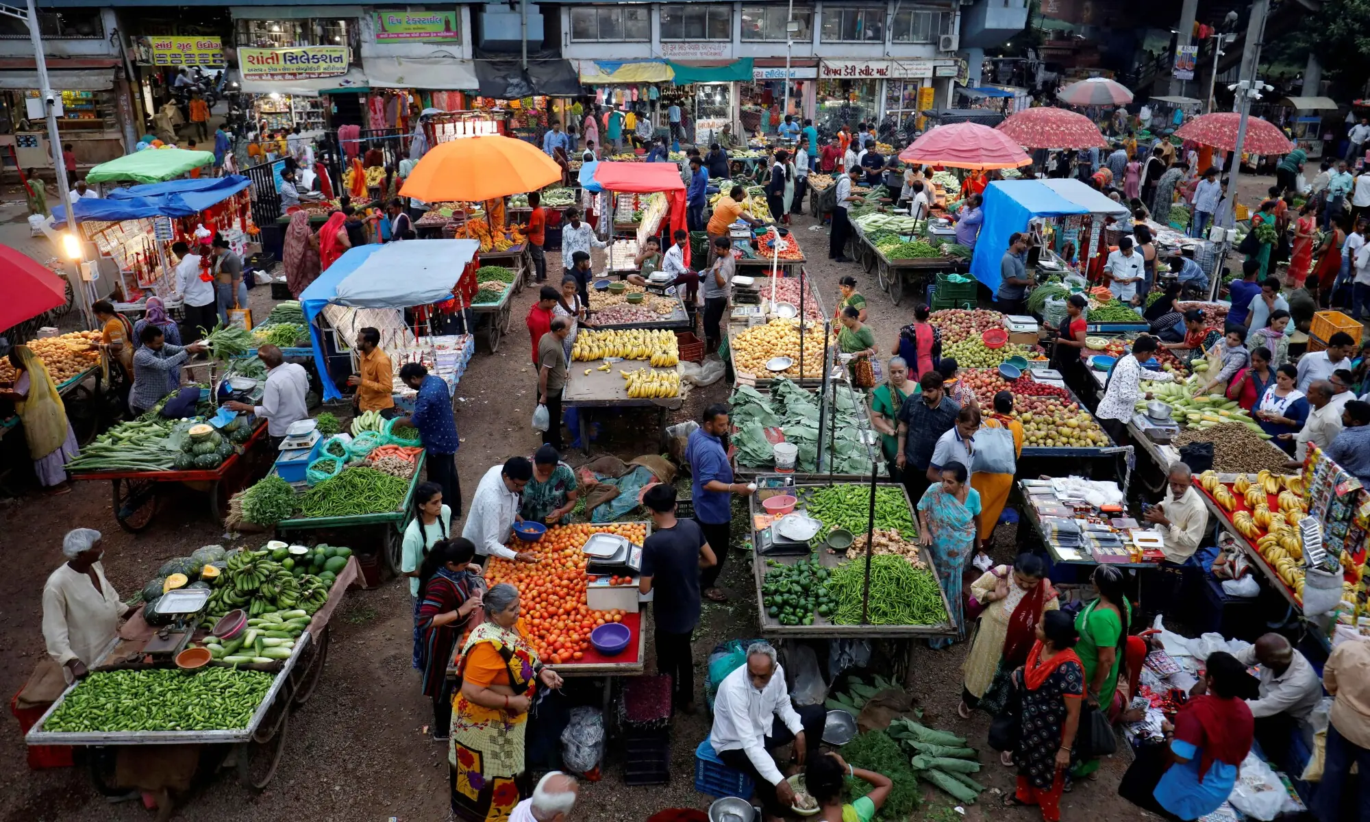 Customers buy fruits and vegetables at an open air evening market in Ahmedabad, India, August 21, 2023. — Reuters Customers buy fruits and vegetables at an open air evening market in Ahmedabad, India, August 21, 2023. — Reuters