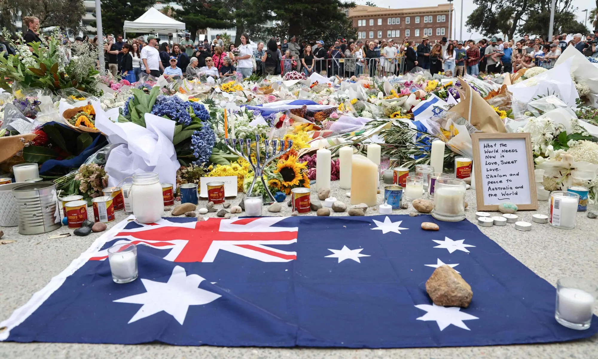 Australia&rsquo;s flag is seen next to floral tributes outside Bondi Pavilion in Sydney on December 16, 2025, in honour of victims of the Bondi Beach shooting. &mdash; AFP