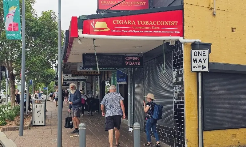 People walk past tobacco shop owned by Ahmed al Ahmed, the bystander who is hailed as the &ldquo;Bondi hero&rdquo; after he charged at one of the gunmen and seized his rifle during the deadly shooting at Bondi Beach, in Sydney, Australia, December 16, 2025. &mdash;Reuters