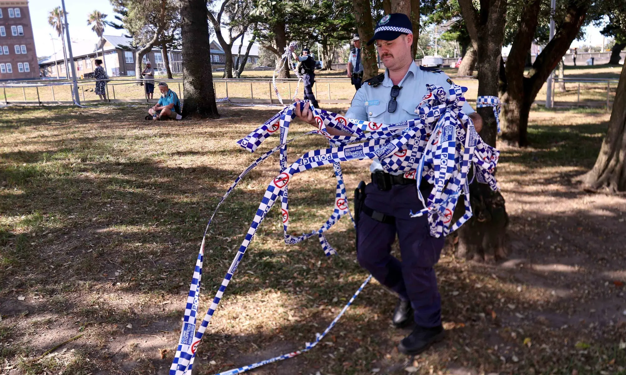 Police officers remove police tape from the scene of Sunday&rsquo;s shooting at Bondi Beach, in Sydney on December 17, 2025. &mdash; AFP