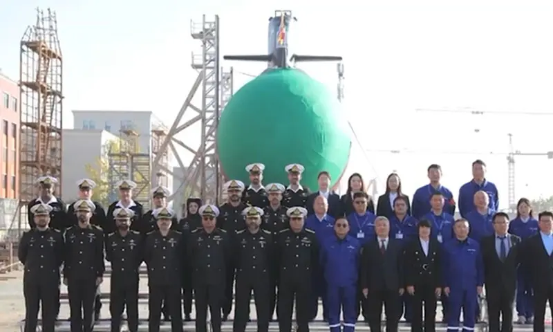 Pakistani and Chinese naval officials celebrate the launch of the Pakistan Navy&rsquo;s fourth Hango-class submarine, the Ghazi, in Wuhan, China on December 17. &mdash; Screengrab via ISPR