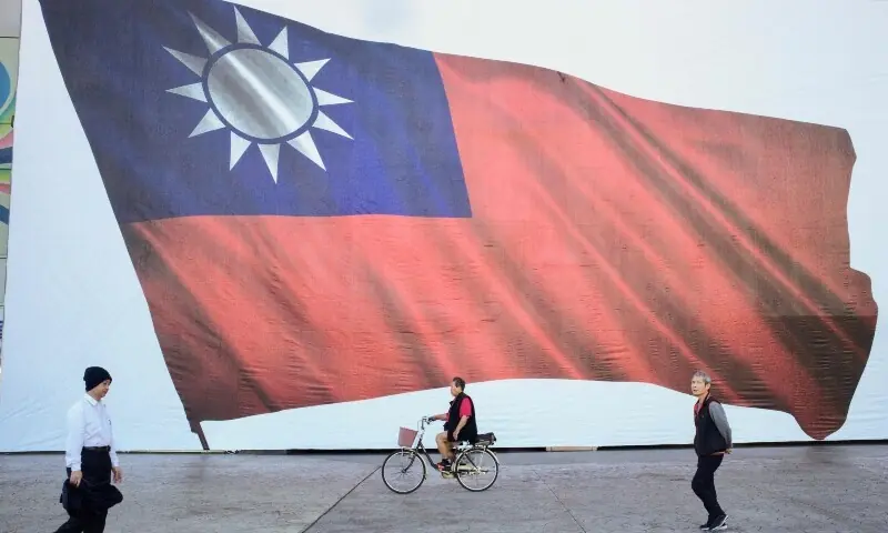 People walk past a Taiwan flag in New Taipei City on January 13, 2024. — Reuters People walk past a Taiwan flag in New Taipei City on January 13, 2024. — Reuters
