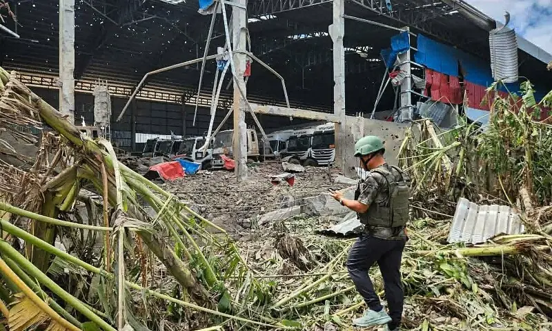 This handout photo made available by Agence Kampuchea Press (AKP) on December 18 shows a man inspecting a garage damaged after Thai air strikes in Poipet town, Banteay Meanchey province. — AFP This handout photo made available by Agence Kampuchea Press (AKP) on December 18 shows a man inspecting a garage damaged after Thai air strikes in Poipet town, Banteay Meanchey province. — AFP