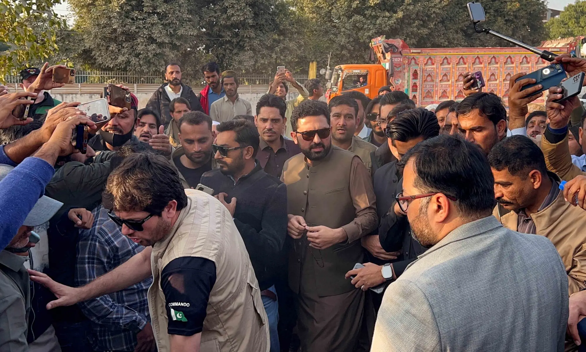 Khyber Pakhtunkhwa Chief Minister Sohail Afridi (C) reacts amidst party supporters of jailed former premier Imran Khan, as they gather to visit him, outside Adiala Jail in Rawalpindi on November 27, 2025. &mdash; Reuters