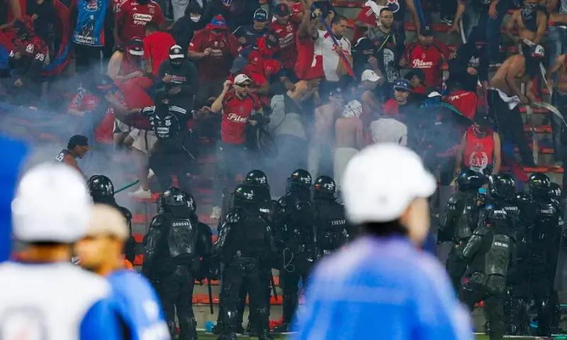 Police stand guard at the end of the Copa Colombia final. — Photo via EPA Police stand guard at the end of the Copa Colombia final. — Photo via EPA