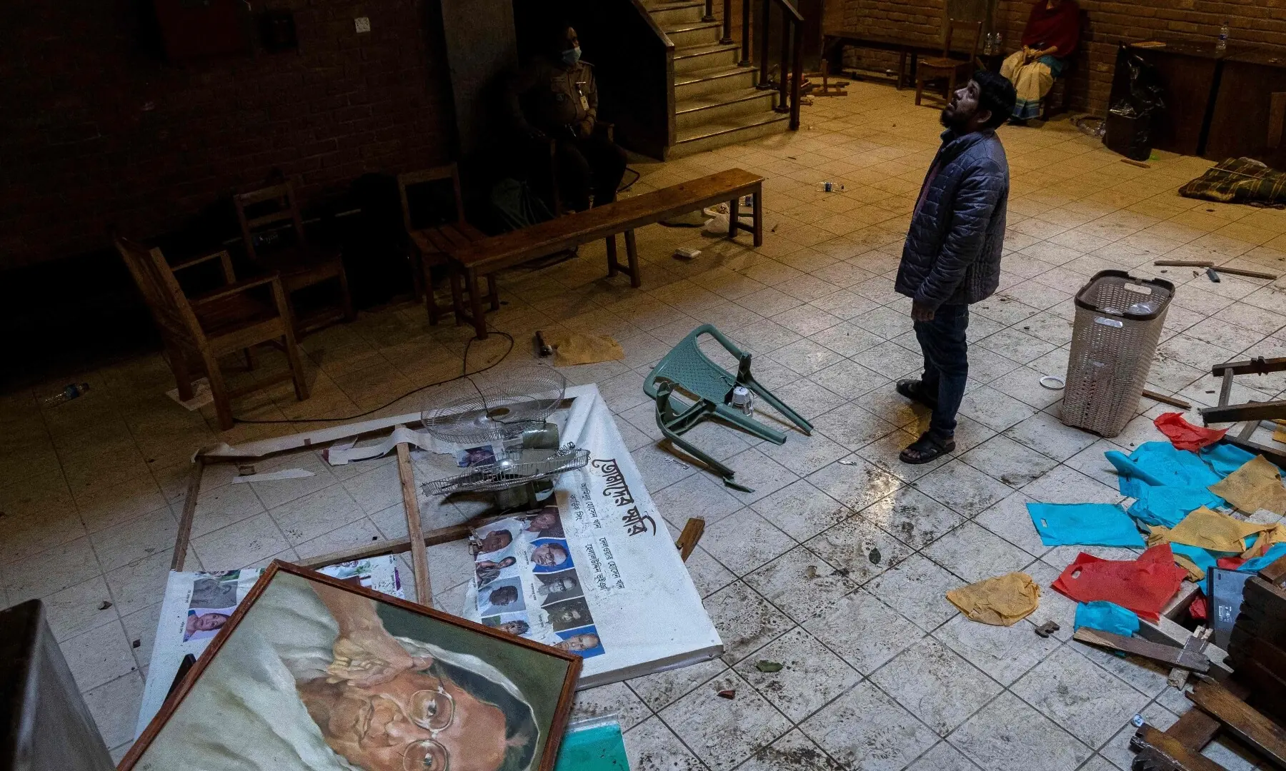 A man looks up as he stands inside the vandalised office of the Chhayanaut in Dhaka on December 19, 2025. &mdash; AFP