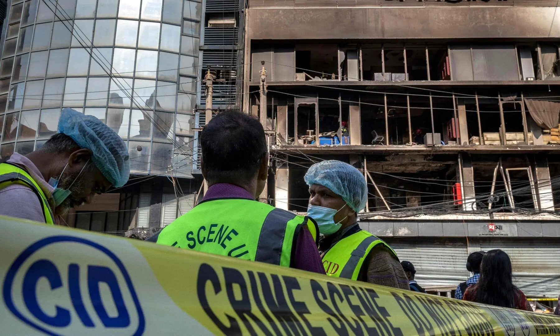 Bangladesh&rsquo;s Criminal Investigation Department (CID) personnel stand outside the burnt and vandalised building of the Prothom Alo newspaper in Dhaka on December 19, 2025. &mdash; AFP