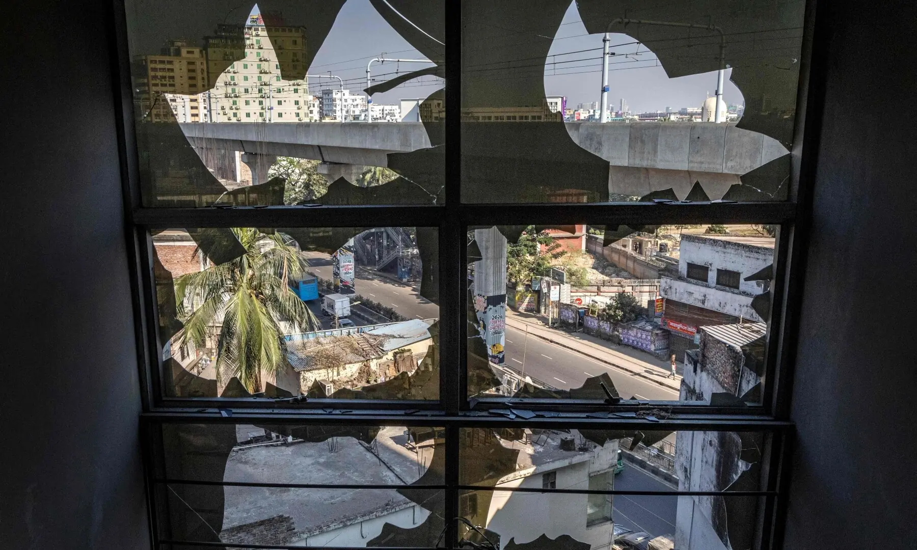 Broken window glasses are pictured inside the vandalised building of The Daily Star newspaper in Dhaka on December 19, 2025. &mdash; AFP