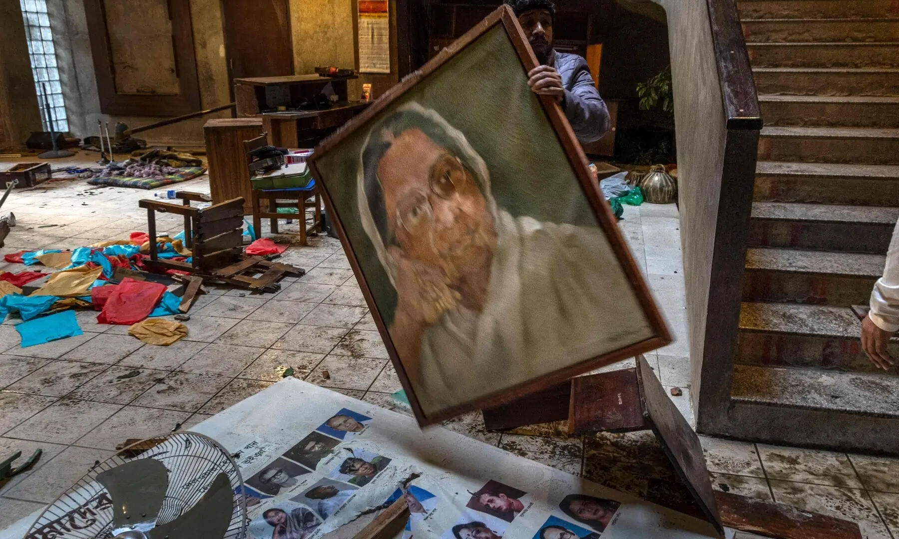 An employee arranges the vandalised office of the Chhayanaut in Dhaka on December 19, 2025. &mdash; AFP