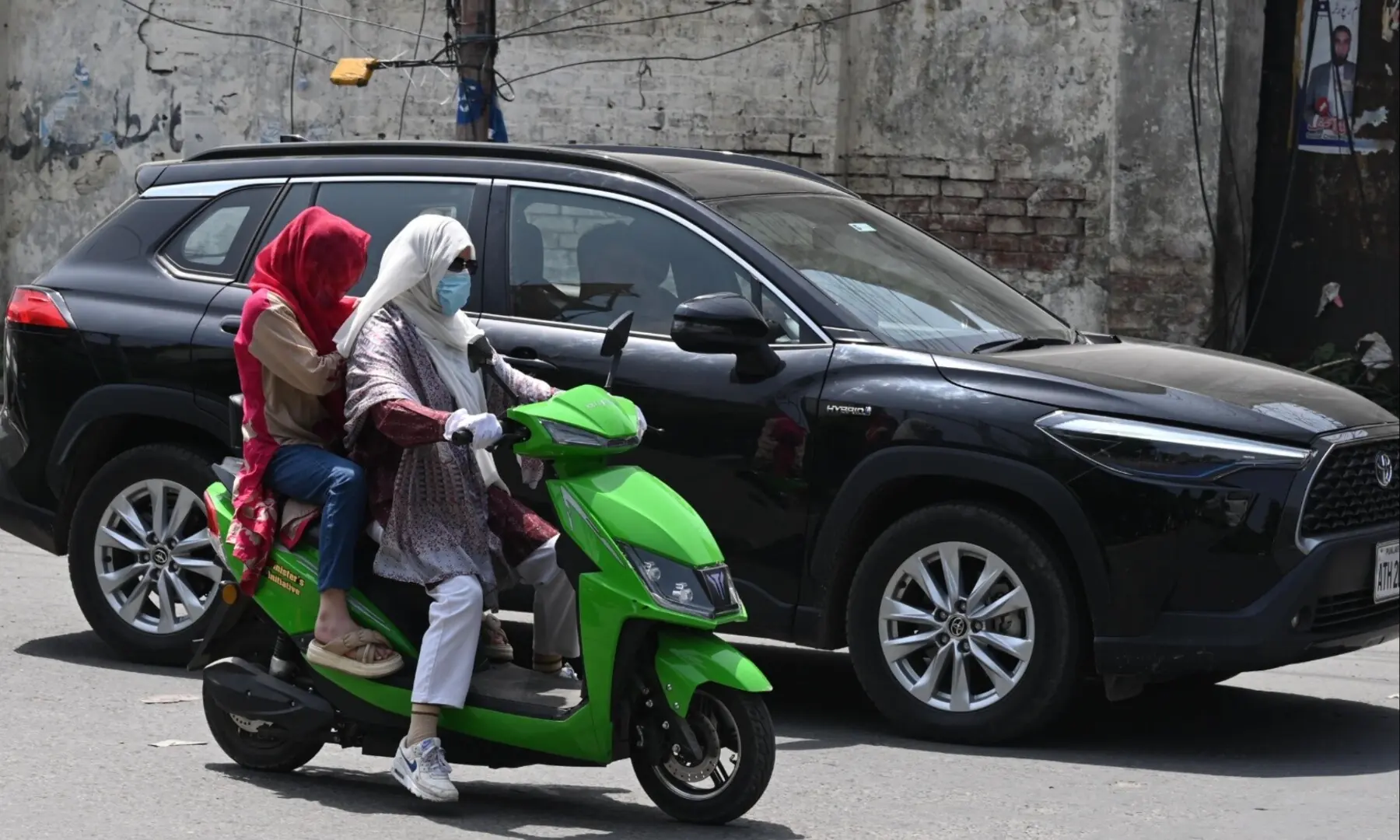 Women riding their scooties on the streets of Lahore. &mdash;Arif Ali/ White Star