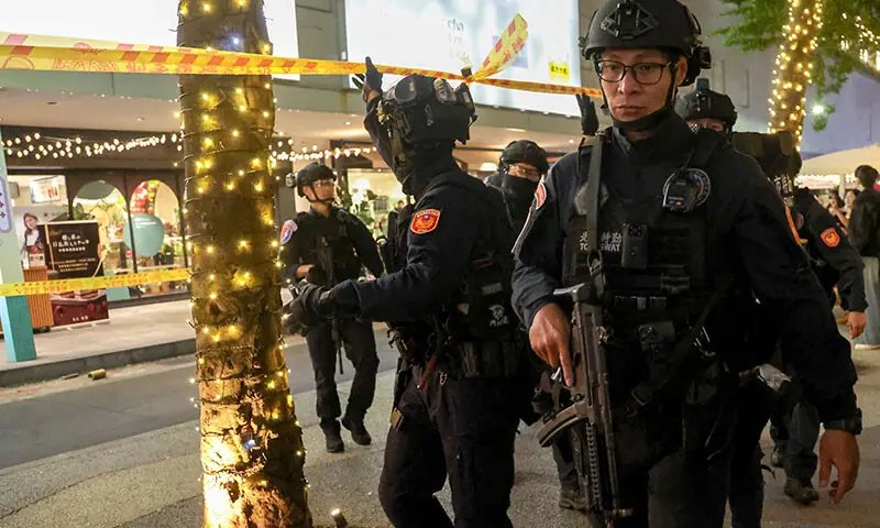 SWAT team members leave Eslite Spectrum Nanxi store near Zhongshan station while the building is cordoned off with yellow crime scene tape, following an attack in Taipei, Taiwan on December 19. &mdash; Reuters