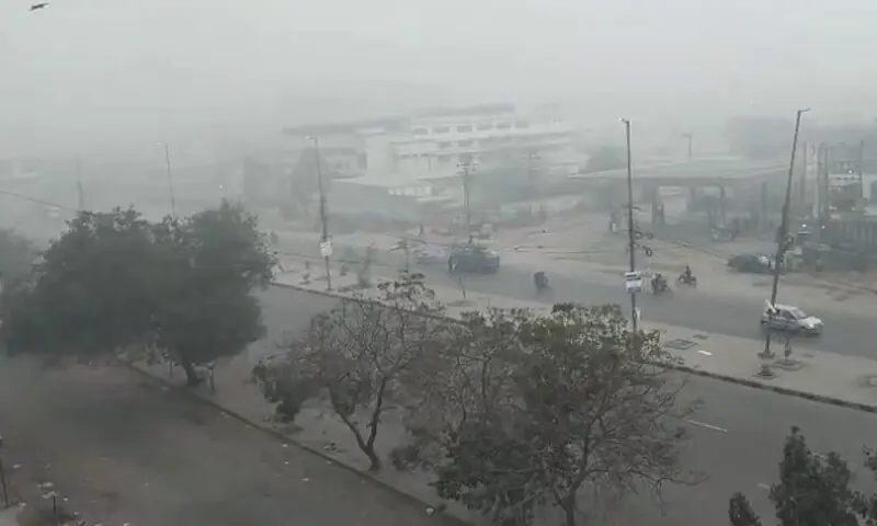 Heavy fog conditions are pictured over a road in Karachi on December 21, 2025. &mdash; Dawn