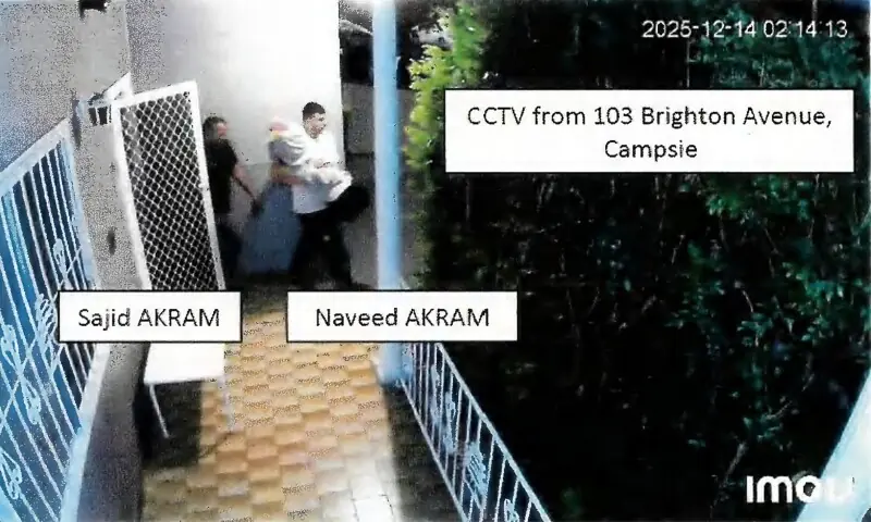 This handout photo from a court exhibit released by the NSW Courts as part of the police facts sheet on December 22, 2025 shows a frame grab taken from closed-circuit television camera (CCTV) video footage of Sajid and Naveed Akram allegedly exiting 103 Brighton Avenue in Campsie on December 14, 2025 as they carried items wrapped in blankets. &mdash; AFP