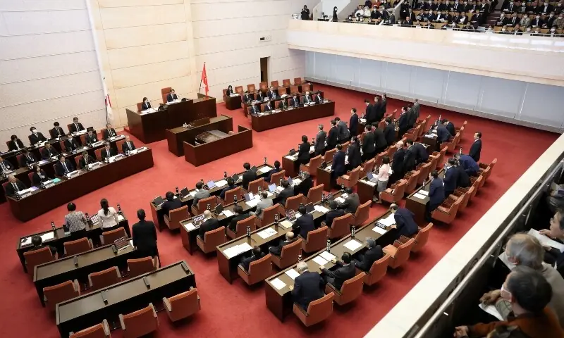 Niigata Prefectural Assembly lawmakers stand up from their seats to show their confidence in Niigata Prefecture Governor Hideyo Hanazumi&rsquo;s decisions on a partial restart of the Tokyo Electric Power Company&rsquo;s (TEPCO)  in Niigata, Japan on December 22, 2025. &mdash; Reuters