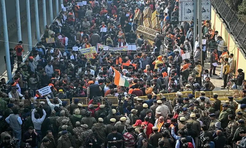 Security personnel try to stop Vishva Hindu Parishad (VHP) activists along with others during a protest march near the Bangladesh High Commission in New Delhi on December 23. —AFP