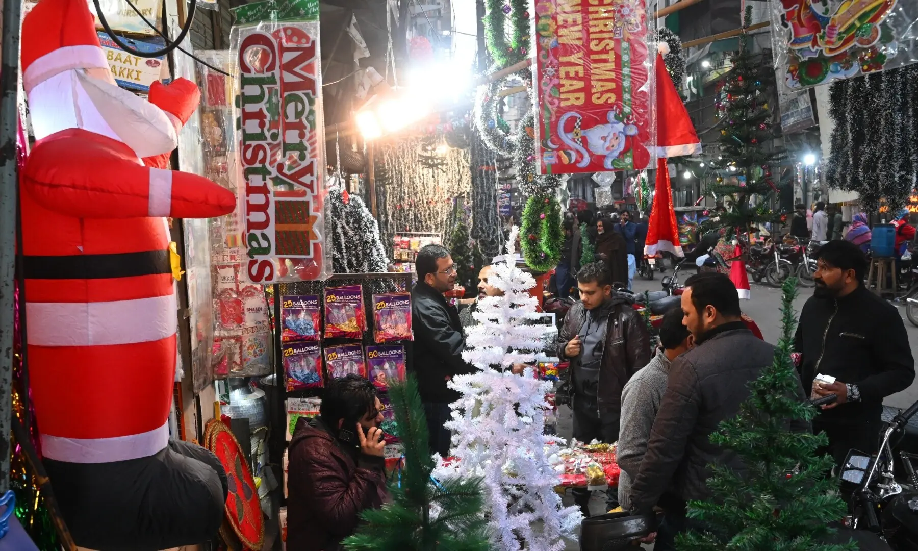 People shopping for Christmas items on Ganpat Road, Lahore. &mdash; Arif Ali