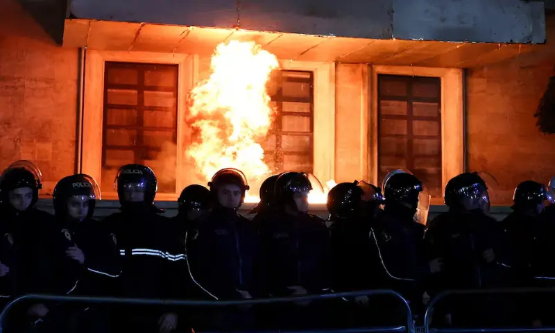 Police officers react to a Molotov cocktail as supporters of the opposition attend an anti-government protest in Tirana, Albania, December 22, 2025. - REUTERS Police officers react to a Molotov cocktail as supporters of the opposition attend an anti-government protest in Tirana, Albania, December 22, 2025. - REUTERS