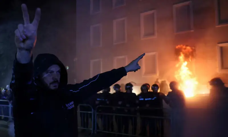 A supporter of the opposition gestures as police officers react to a Molotov cocktail during an anti-government protest, in Tirana, Albania, December 22, 2025 - REUTERS A supporter of the opposition gestures as police officers react to a Molotov cocktail during an anti-government protest, in Tirana, Albania, December 22, 2025 - REUTERS