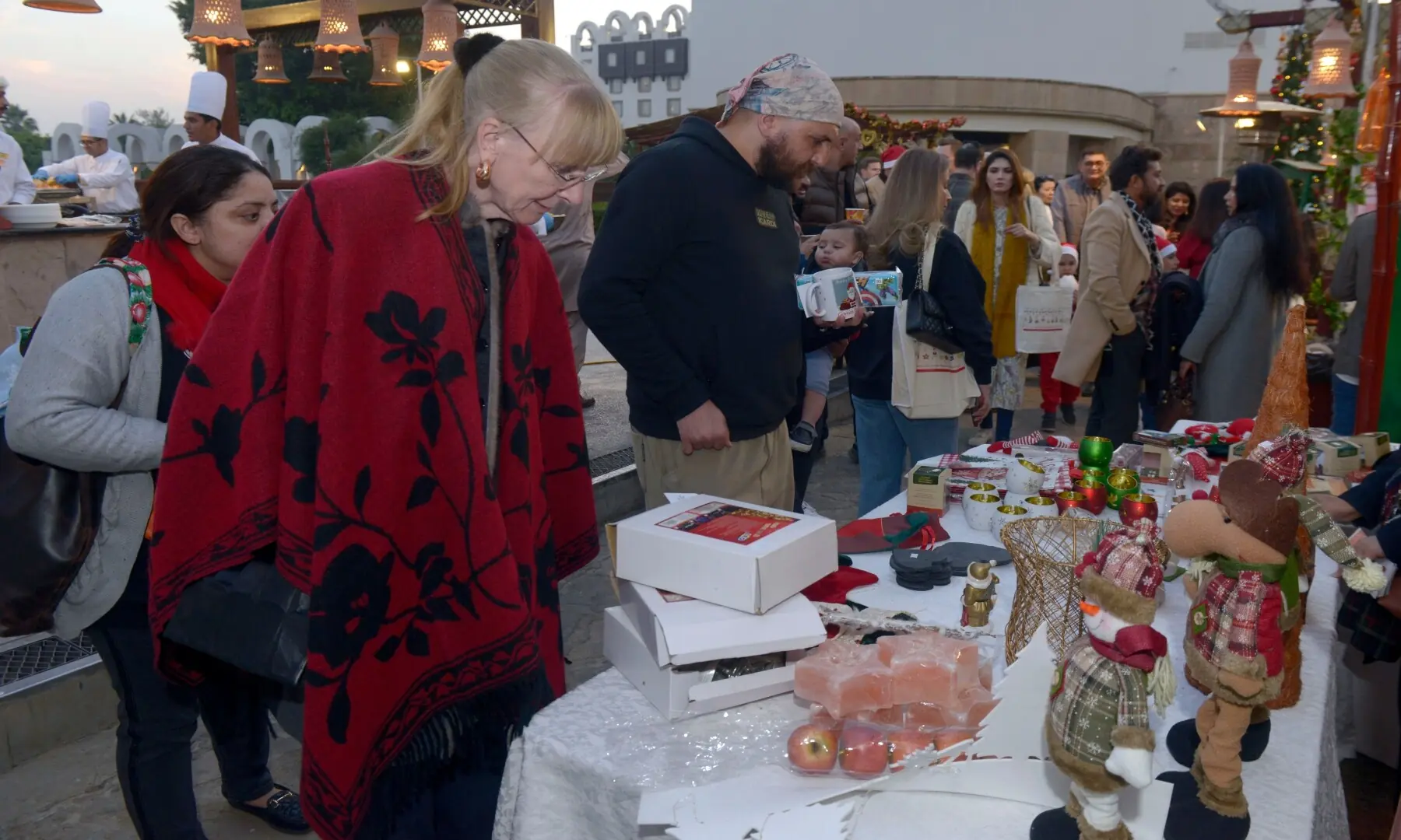Visitors look at various items on display on stalls while at the Christmas Charity Market organised by the German embassy in Islamabad. &mdash;  Mohammad Asim/White Star