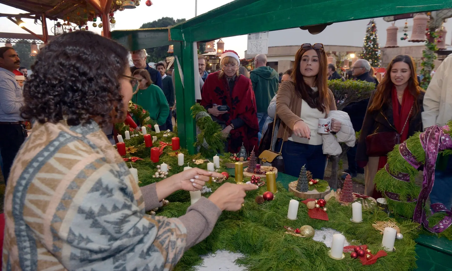 Visitors look at various items on display on stalls while at the Christmas Charity Market organised by the German embassy in Islamabad. &mdash; Mohammad Asim/White Star