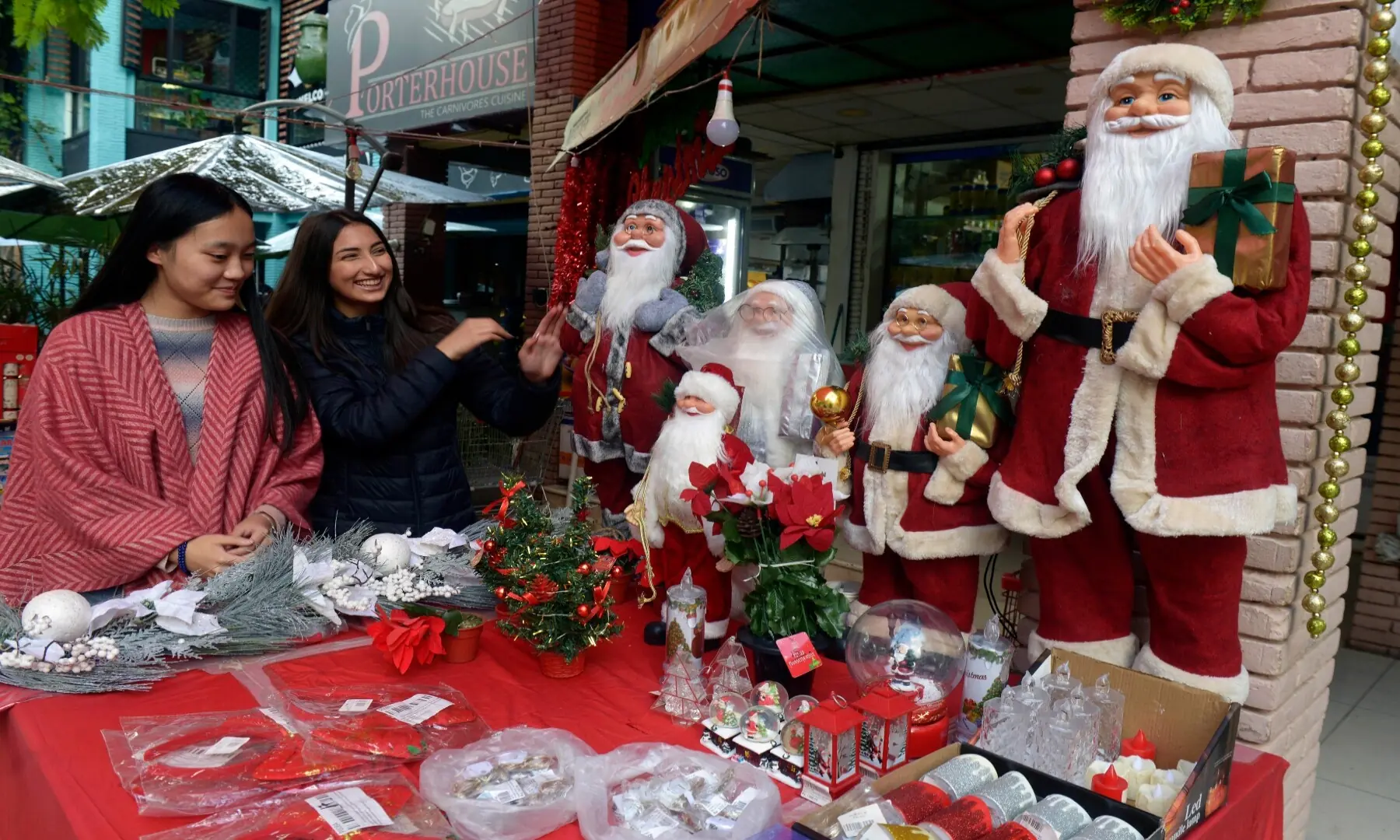 A girl is all smiles as she purchases Christmas-related decorative items on display at a stall in Islamabad&rsquo;s Kohsar Market.  &mdash;Mohammad Asim/White Star
