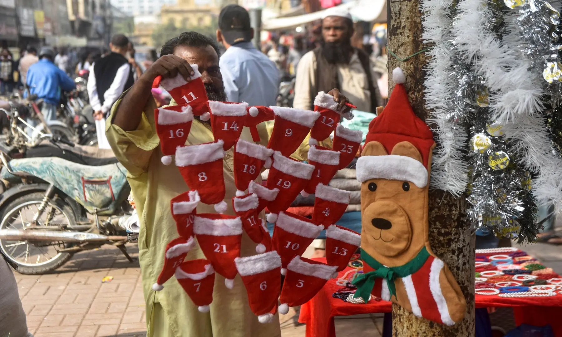A vendor sells Christmas hats at a roadside stall in a Karachi market. &mdash; Fahim Siddiqui/White Star
