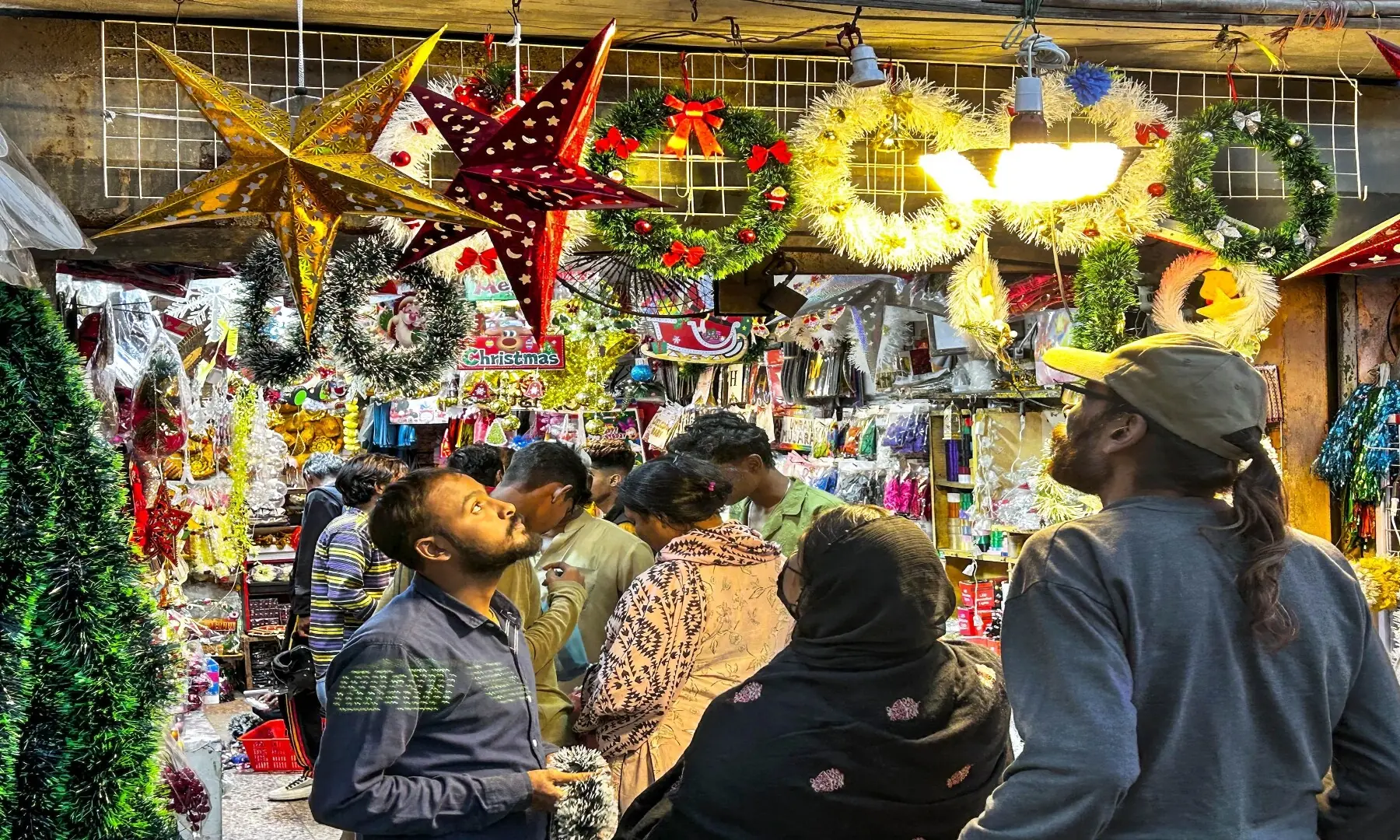 Large Christmas stars hanging at a shop in Bohri Bazaar grabs a passer-by&rsquo;s attention. &mdash; Fahim Siddiqui/ White Star