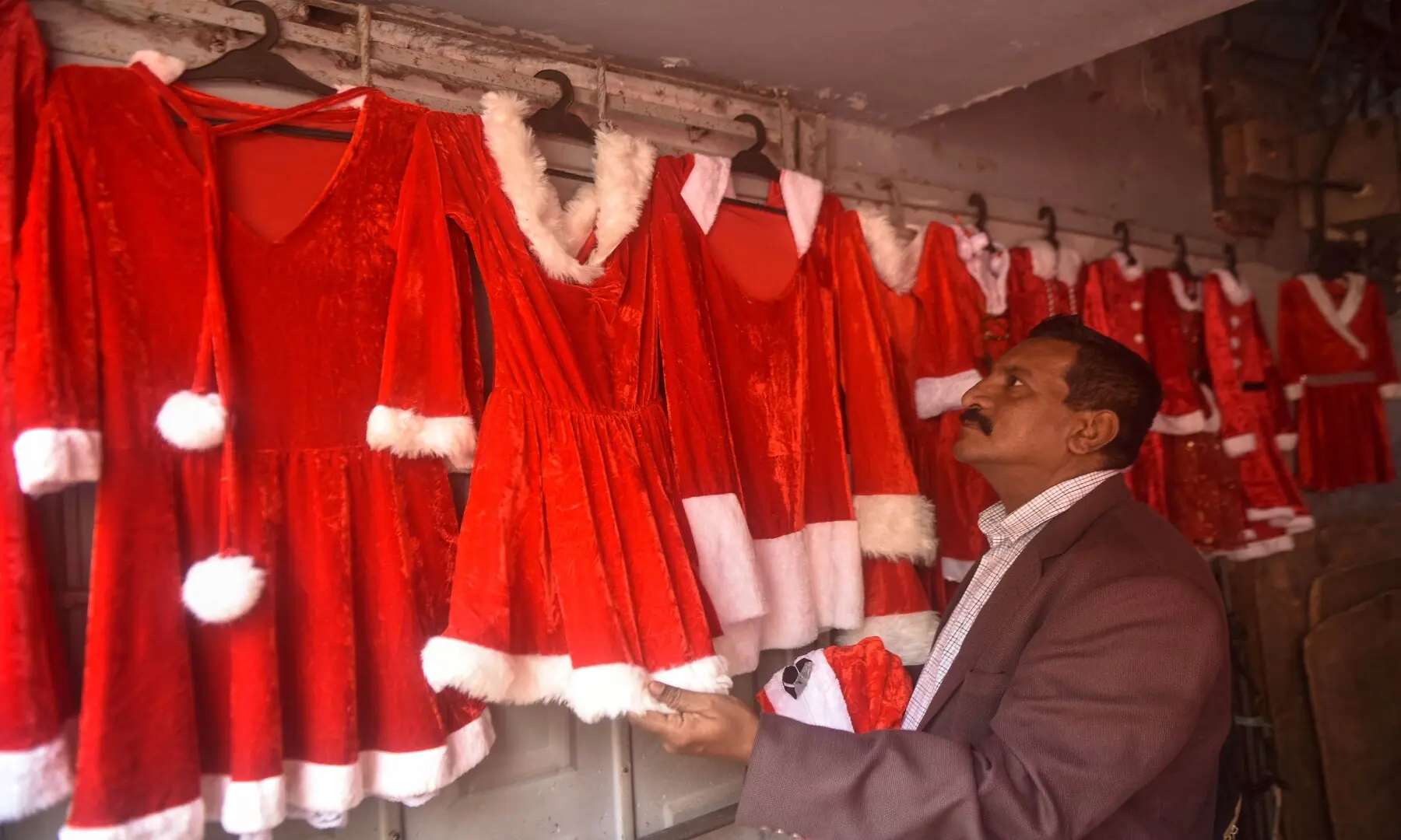 A shop displays red Christmas costumes for women and girls in Karachi. &mdash; Fahim Siddiqui/White Star