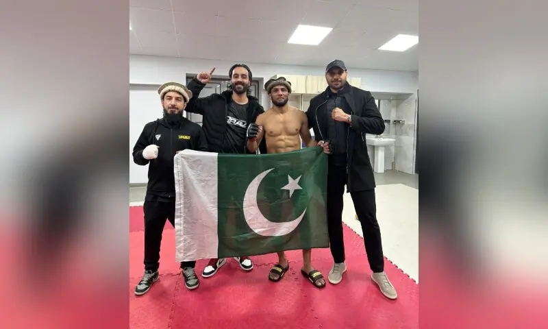 Ismail &lsquo;The Volcano&rsquo; Khan stands backstage with Pakistan MMA Federation President Omar Ahmed and his coaches after winning his Brave CF 103 bout against Rayimbek Tazhibaev in Bukhara, Uzbekistan on December 23. &mdash; Photo courtesy PakMMAF