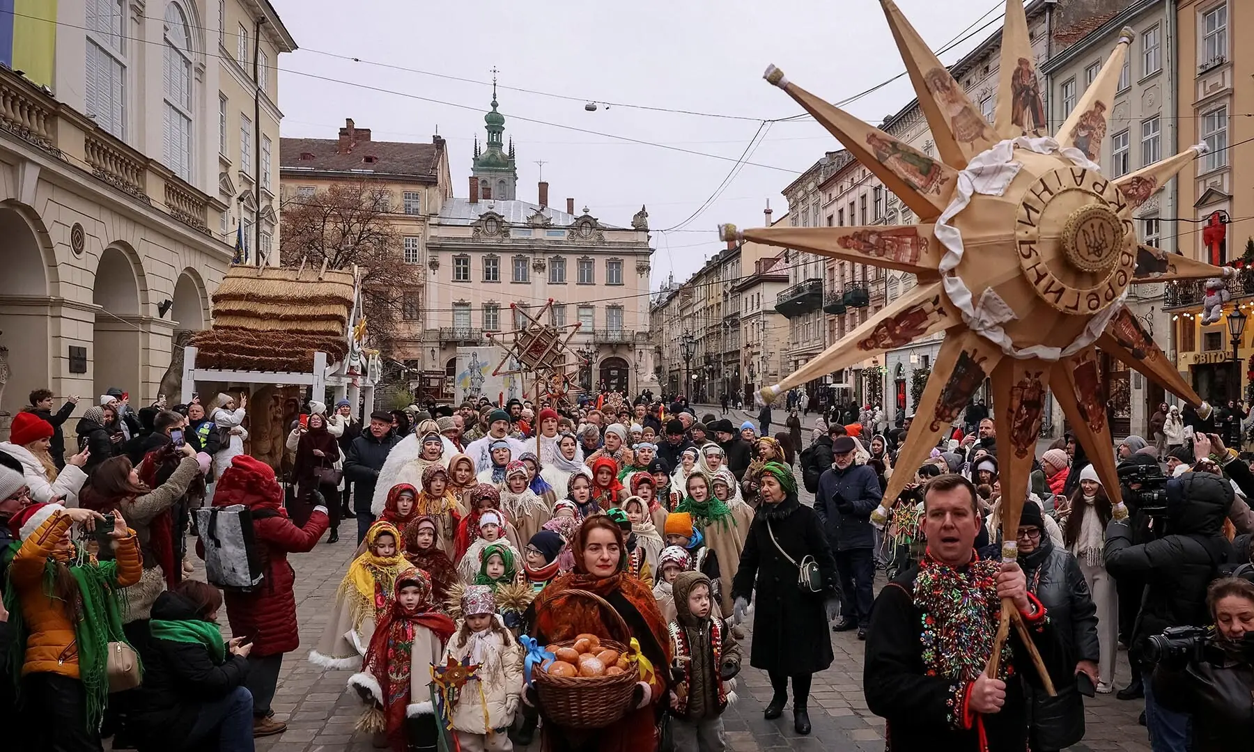 People dressed in traditional Ukrainian attire attend a Christmas celebration in Lviv, Ukraine on December 24. &mdash; Reuters