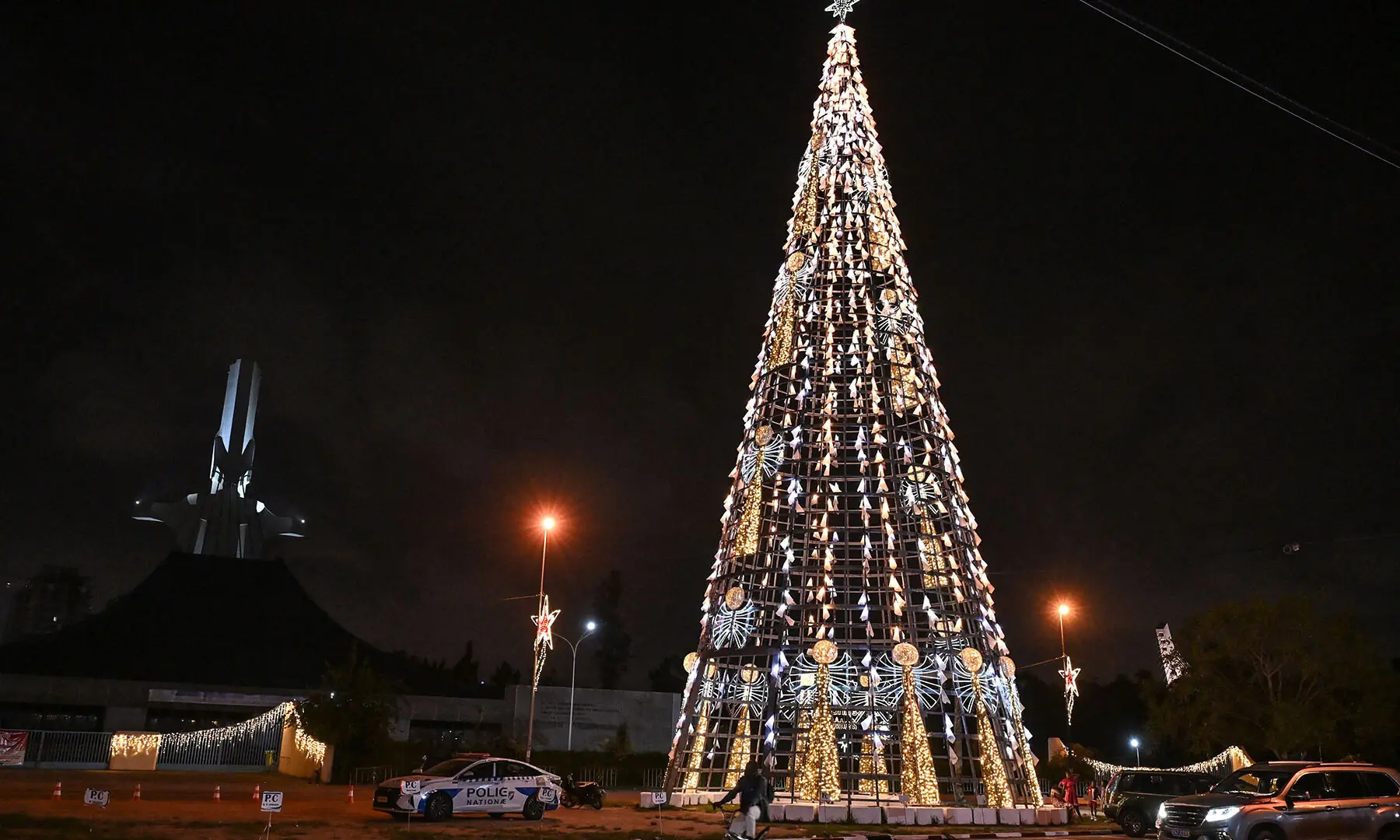A cyclist passes near a giant Christmas in Abidjan, in Cote d&rsquo;Ivoire on December 23, ahead of Christmas. &mdash; AFP