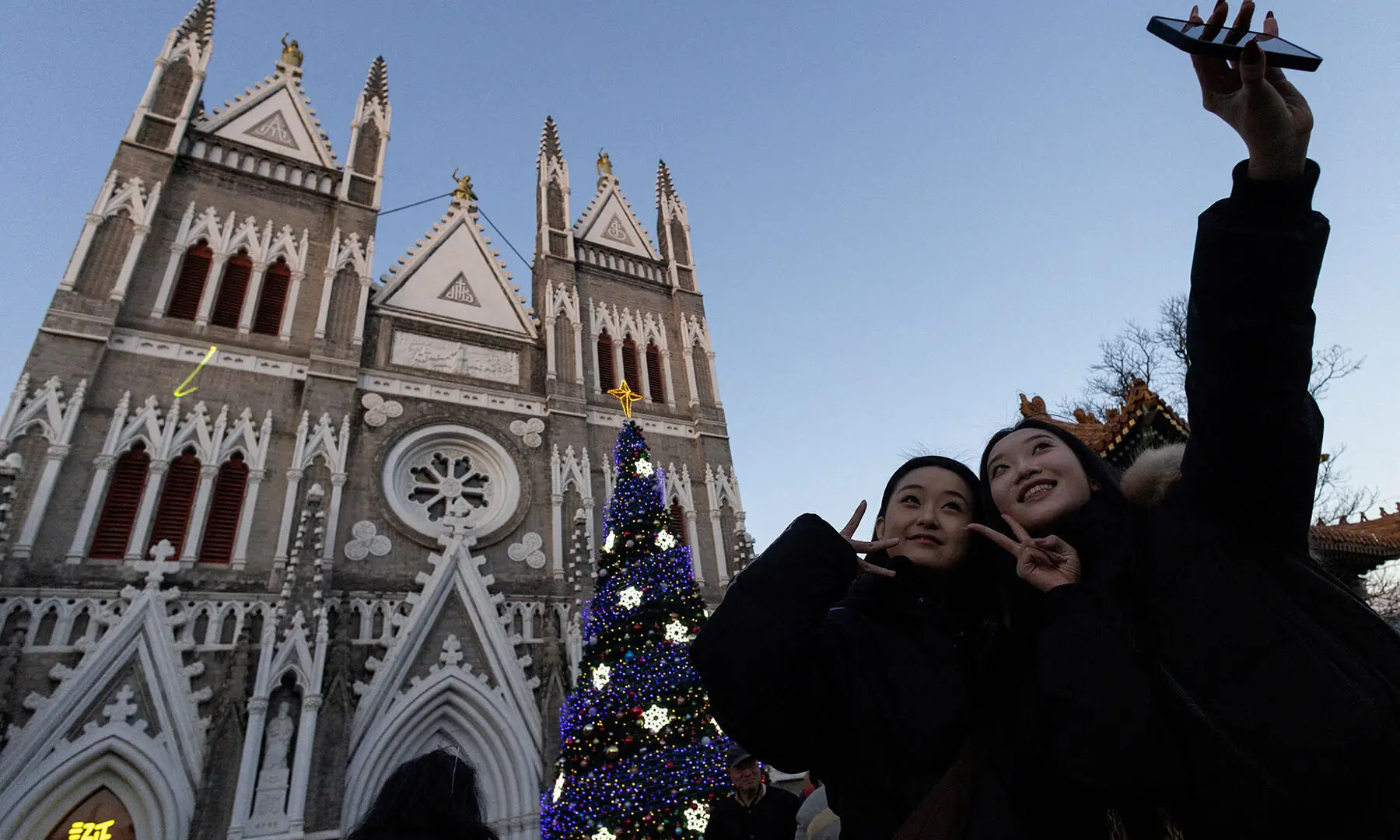 Young women take a selfie in front of Xishiku&nbsp;Church, also known as the North Church, on&nbsp;Christmas&nbsp;Eve  in&nbsp;Beijing, China on December 24. &mdash; Reuters
