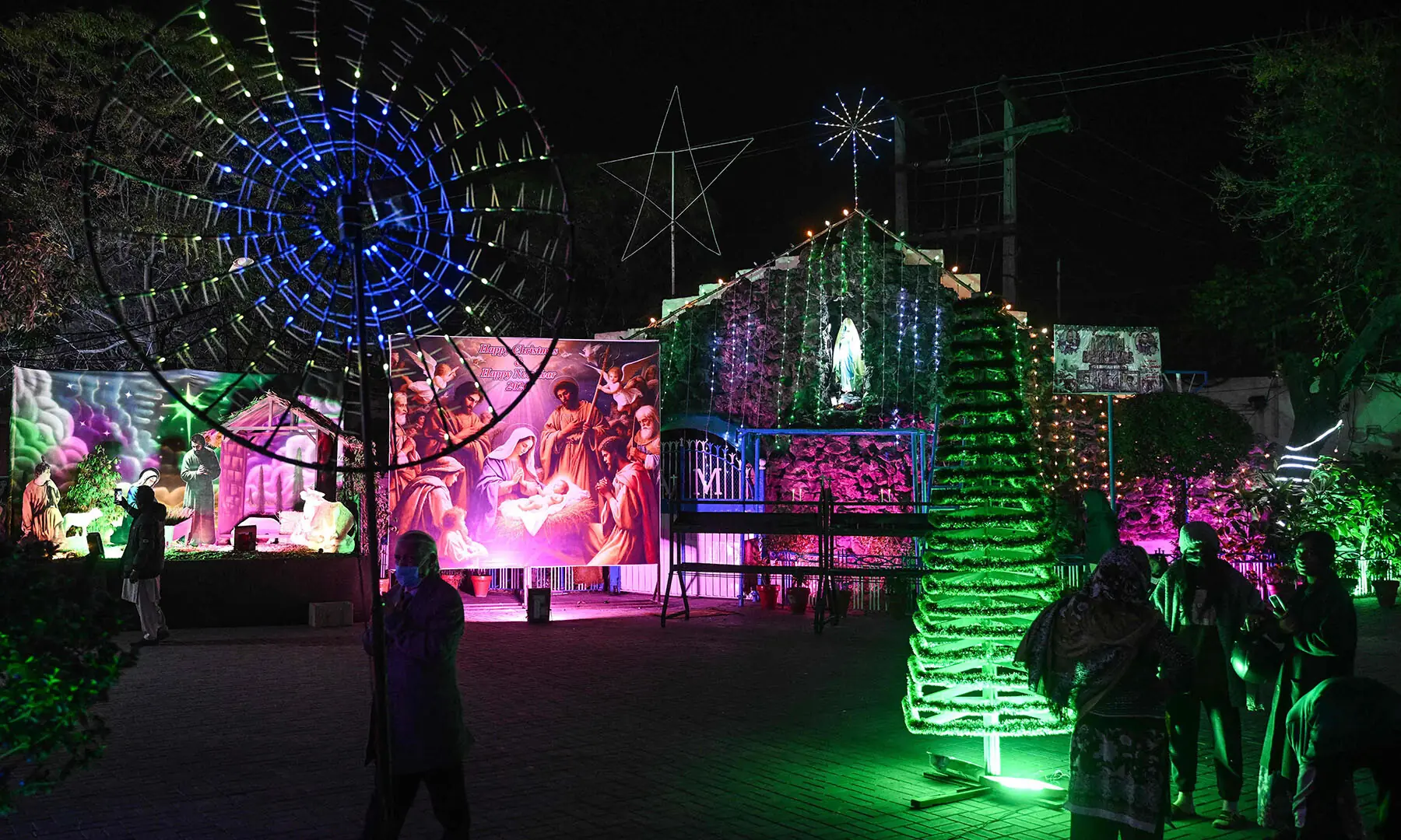 People visit St. Anthony’s Church, decorated on Christmas Eve, in Lahore on December 24. — AFP