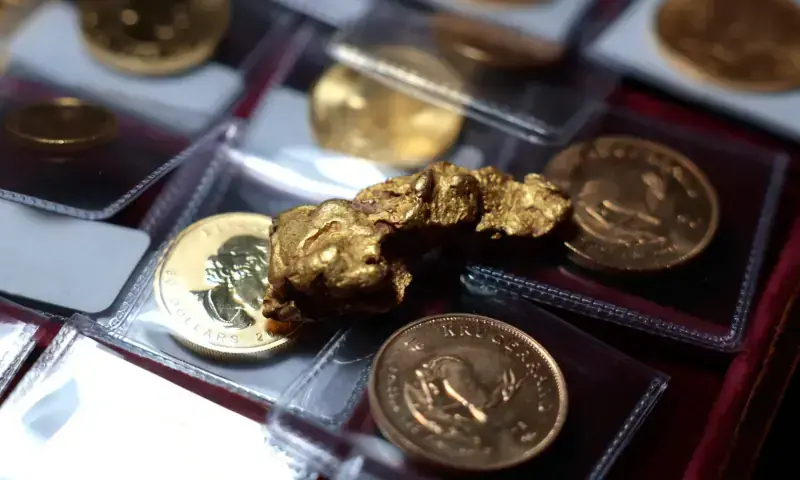 In this photo illustration, a gold nugget sits on top of gold coins at Witter Coins on October 07, 2025 in San Francisco, California. &mdash; AFP