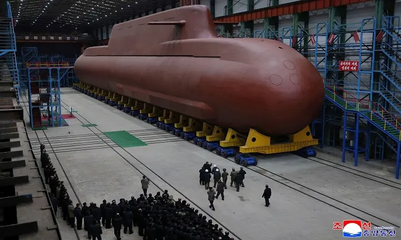The picture released by North Korea&rsquo;s official Korean Central News Agency (KCNA) on December 25 shows North Korean leader Kim Jong Un visiting the manufacturing site of an 8,700-tonnage nuclear-powered strategic guided missile submarine at an undisclosed location in North Korea. &mdash;AFP