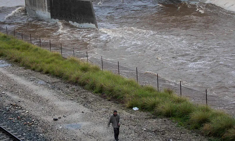 A man walks along the Los Angeles river during heavy rainfall in Los angeles, California, the US on December 24. — AFP