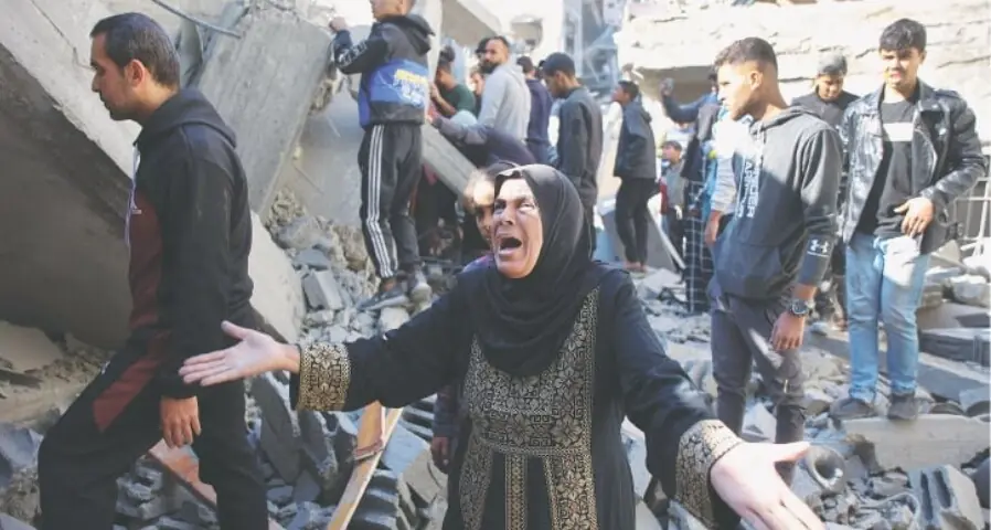 A Palestinian woman stands amid the rubble of a building destroyed in an Israeli strike on the Shujaiyah neighbourhood of Gaza City, on Saturday. &mdash;AFP