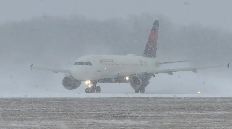 A Delta Air Lines plane prepares to take off during a winter storm at Greater Rochester International Airport in Rochester, New York, US on December 26. &mdash; Reuters