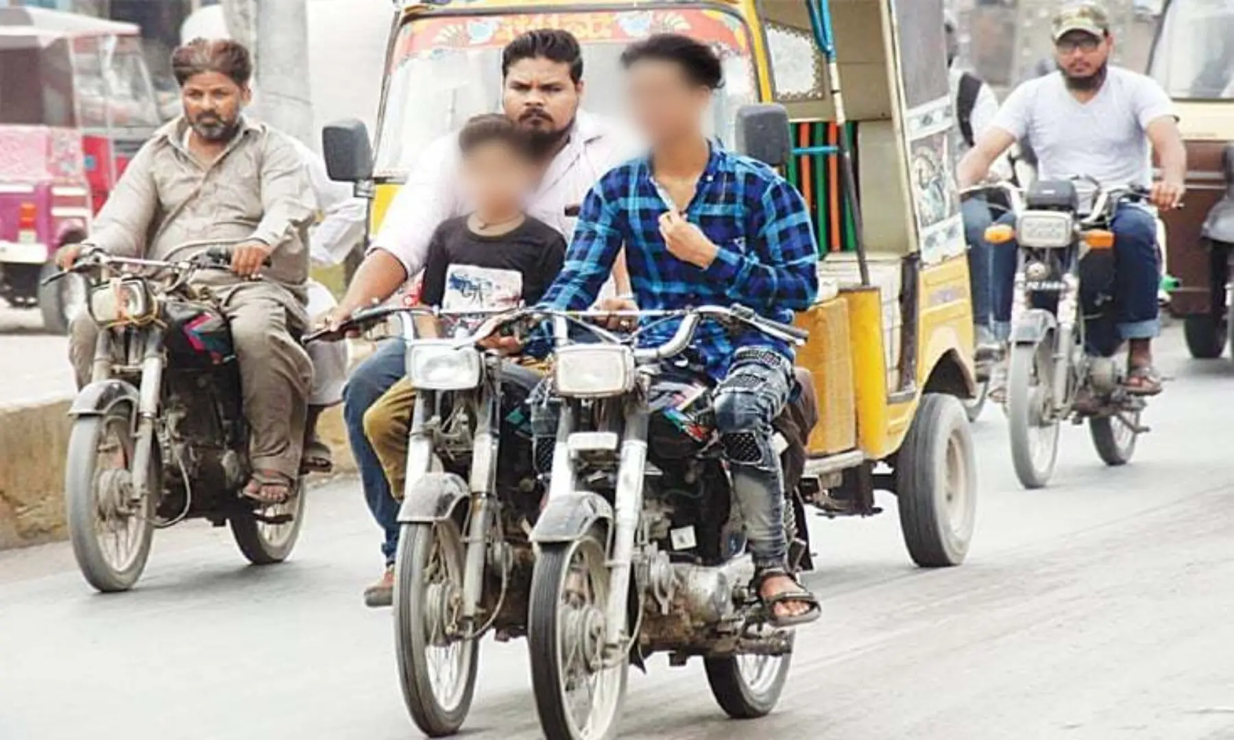   This file photo shows underage motorcyclists on the road in Pakistan. &mdash; Online/File  