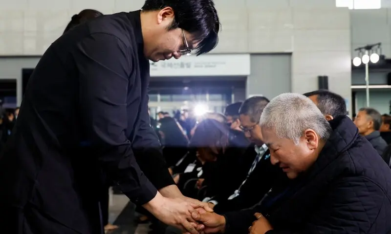 A bereaved family member and attendee hold hands during a memorial ceremony marking the first anniversary of the Jeju Air crash, which claimed 179 lives, at Muan International Airport in Muan, South Korea, December 29. — Reuters A bereaved family member and attendee hold hands during a memorial ceremony marking the first anniversary of the Jeju Air crash, which claimed 179 lives, at Muan International Airport in Muan, South Korea, December 29. — Reuters
