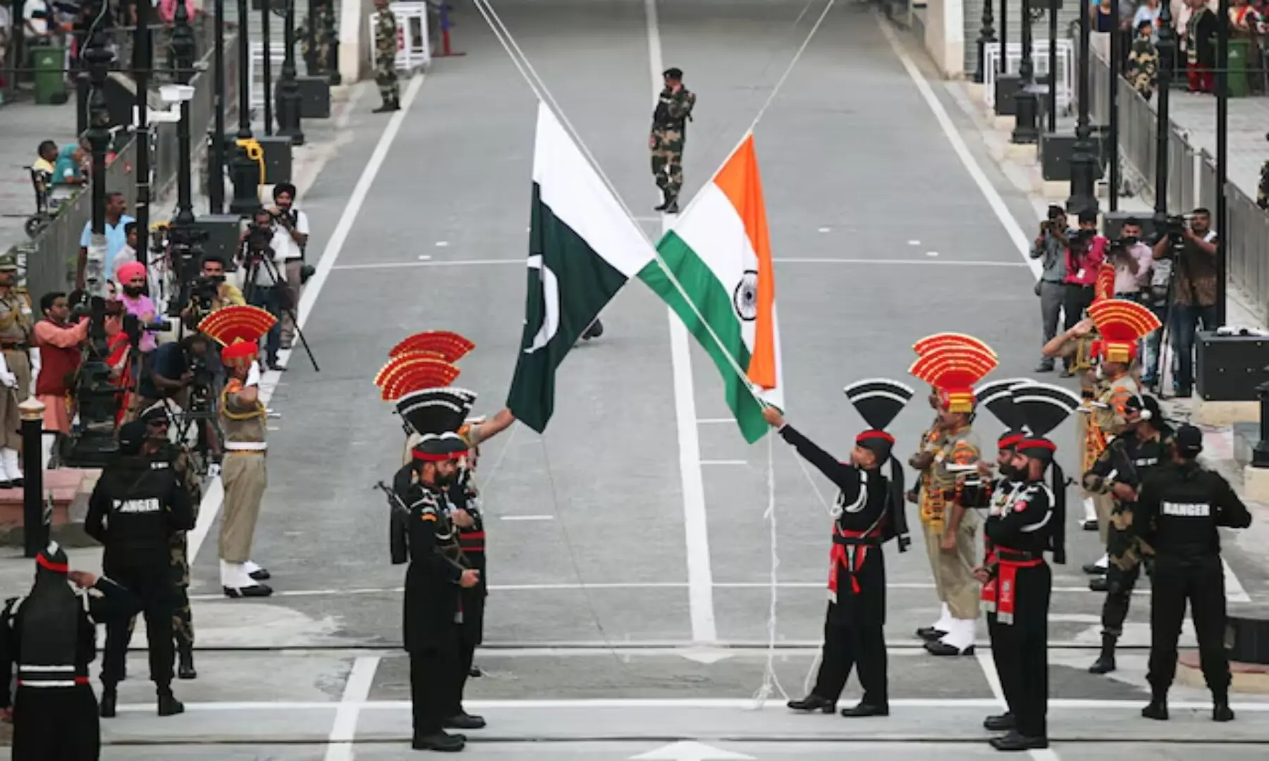  Pakistani Rangers (wearing black uniforms) and Indian Border Security Force (BSF) officers lower their national flags during a parade on Pakistan&rsquo;s 72nd Independence Day, at the Pakistan-India joint check-post at Wagah border, near Lahore, Pakistan, August 14, 2019. &mdash; Reuters/ Mohsin Raza 