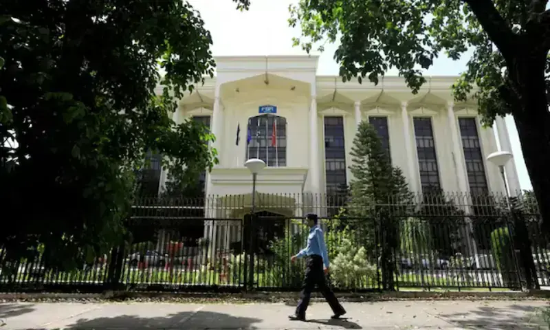 In this file photo, a policeman walks past the Federal Board of Revenue (FBR) office building in Islamabad on August 29, 2018. &mdash; Reuters/File Photo
