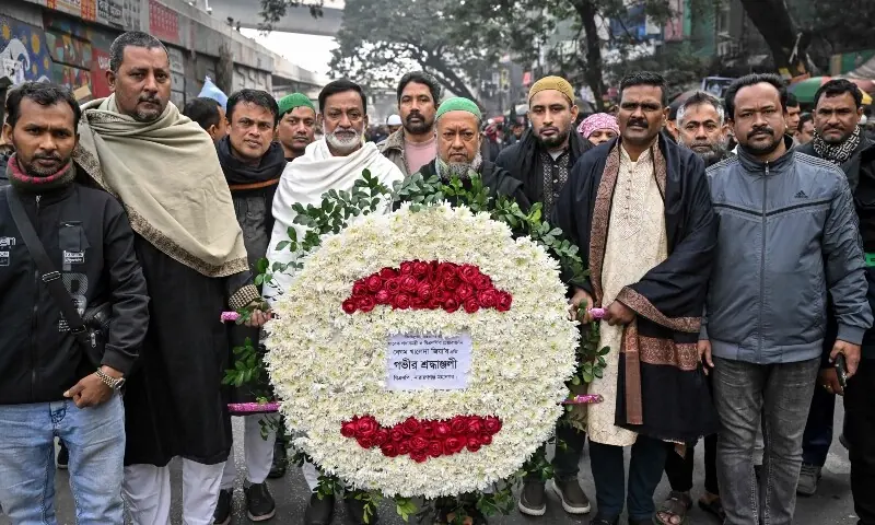 Supporters of Bangladesh&rsquo;s former prime minister Khaleda Zia carry a wreath to mourn her death as they gather before the funeral ceremony in Dhaka on December 31, 2025. &mdash; AFP
